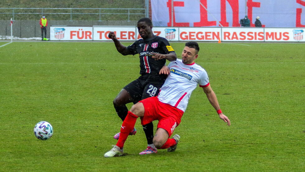 Davy Frick grätscht gegen Halle's Braydon Manu